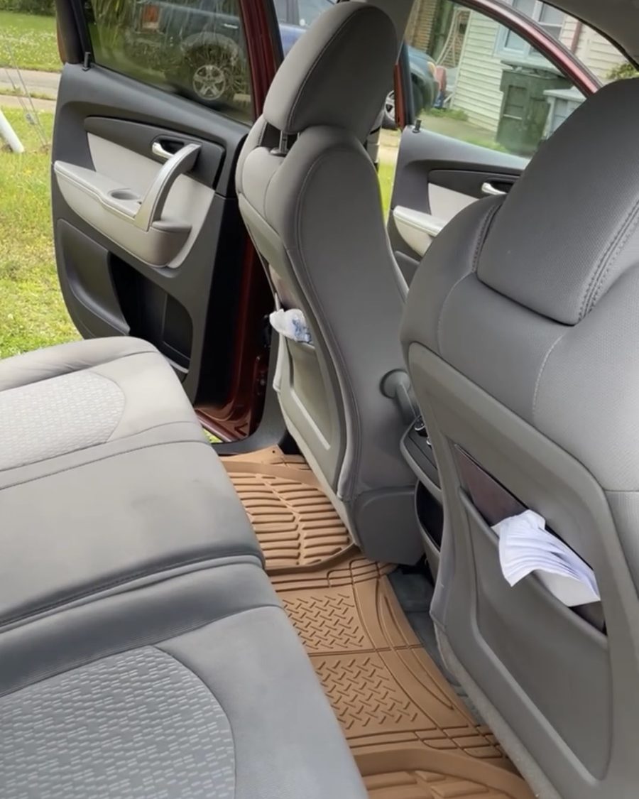Same vehicle interior after detailing — clean seats and floor mats